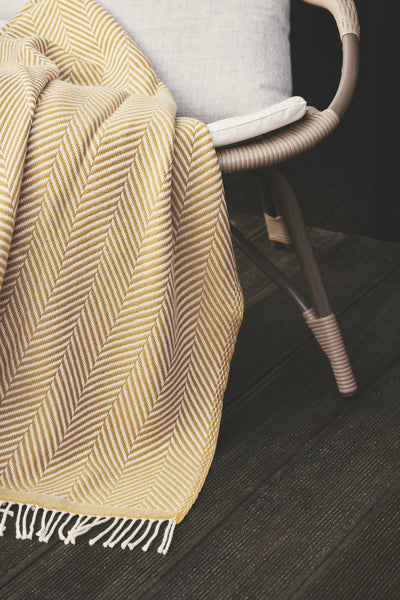 Wool throws and cushions under the open sky